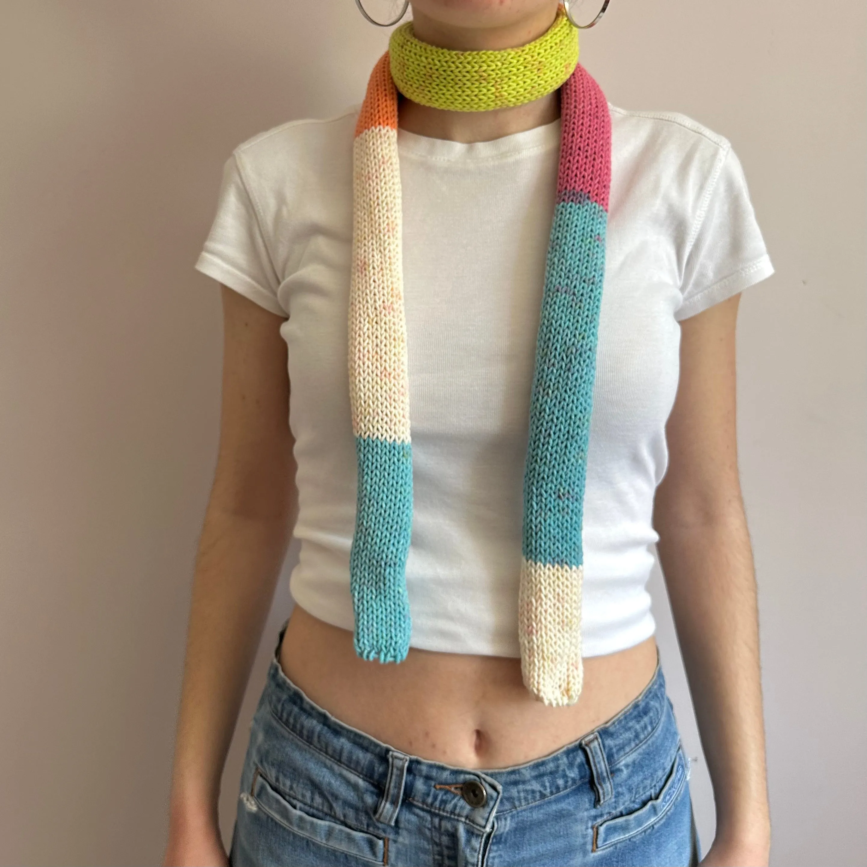 Handmade knitted colour block skinny scarf in blue, cream, orange, pink and green