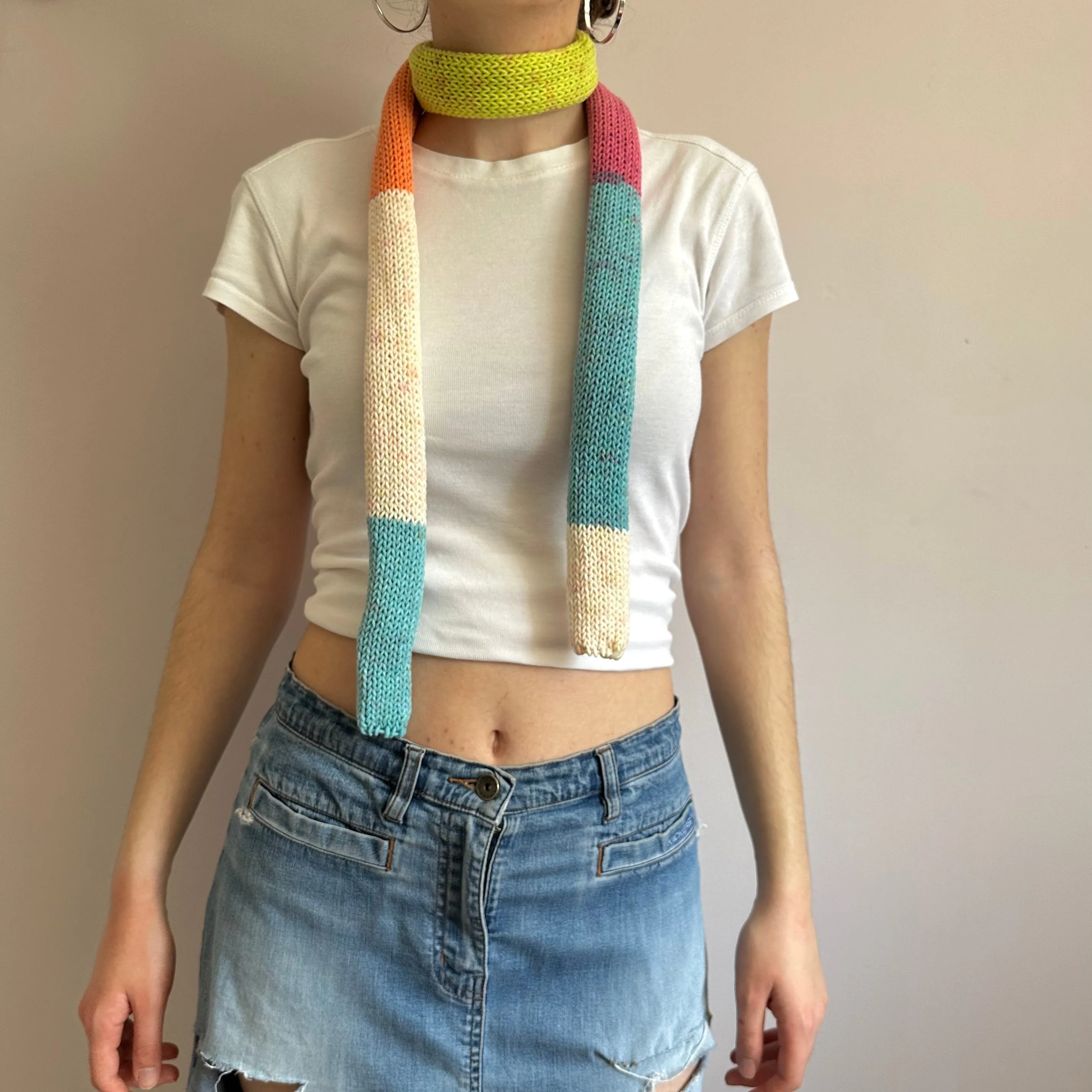 Handmade knitted colour block skinny scarf in blue, cream, orange, pink and green