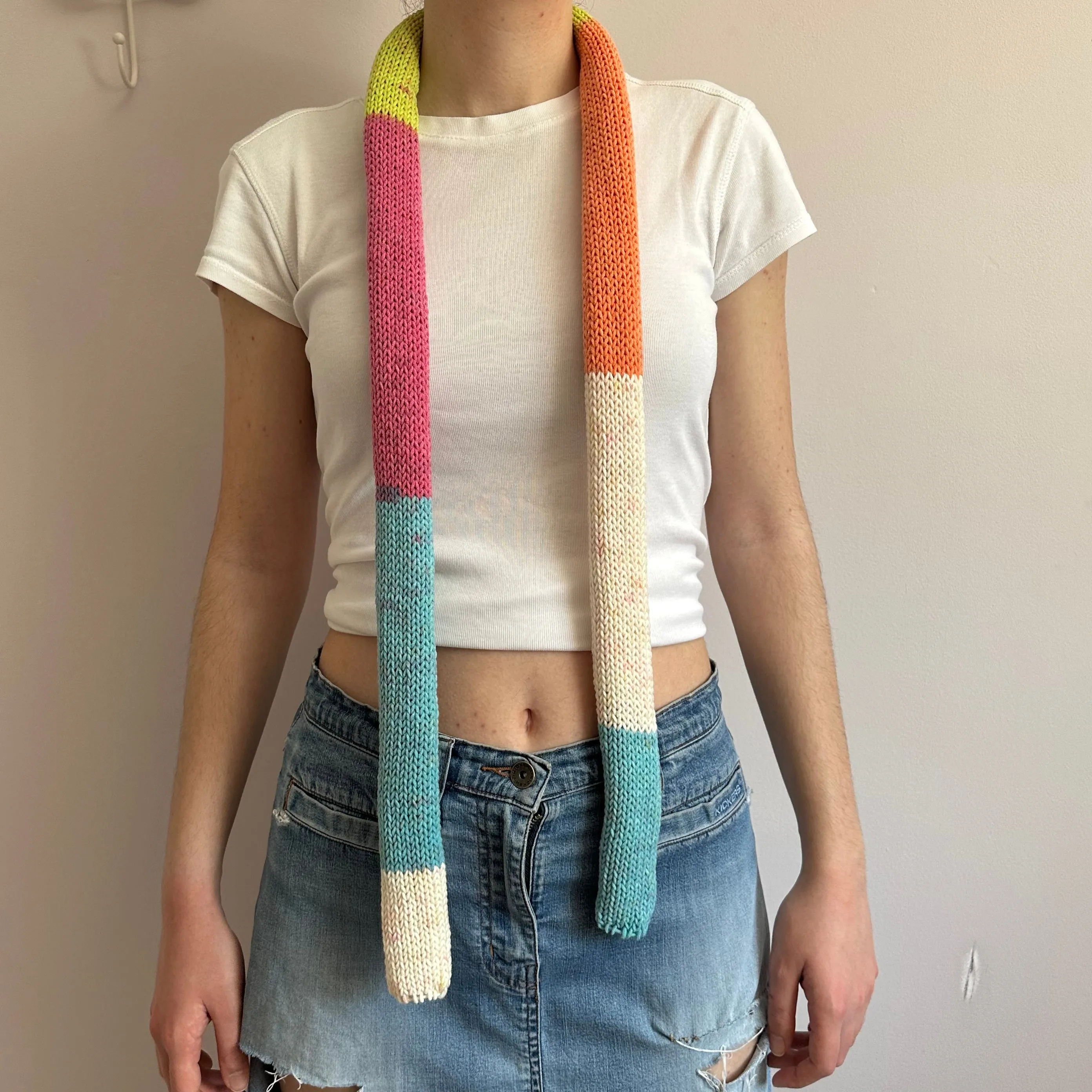 Handmade knitted colour block skinny scarf in blue, cream, orange, pink and green